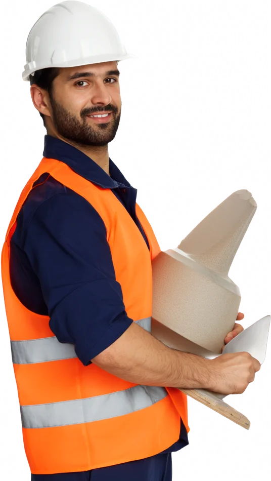 Builder in a hard hat holding a trowel and floor tiles